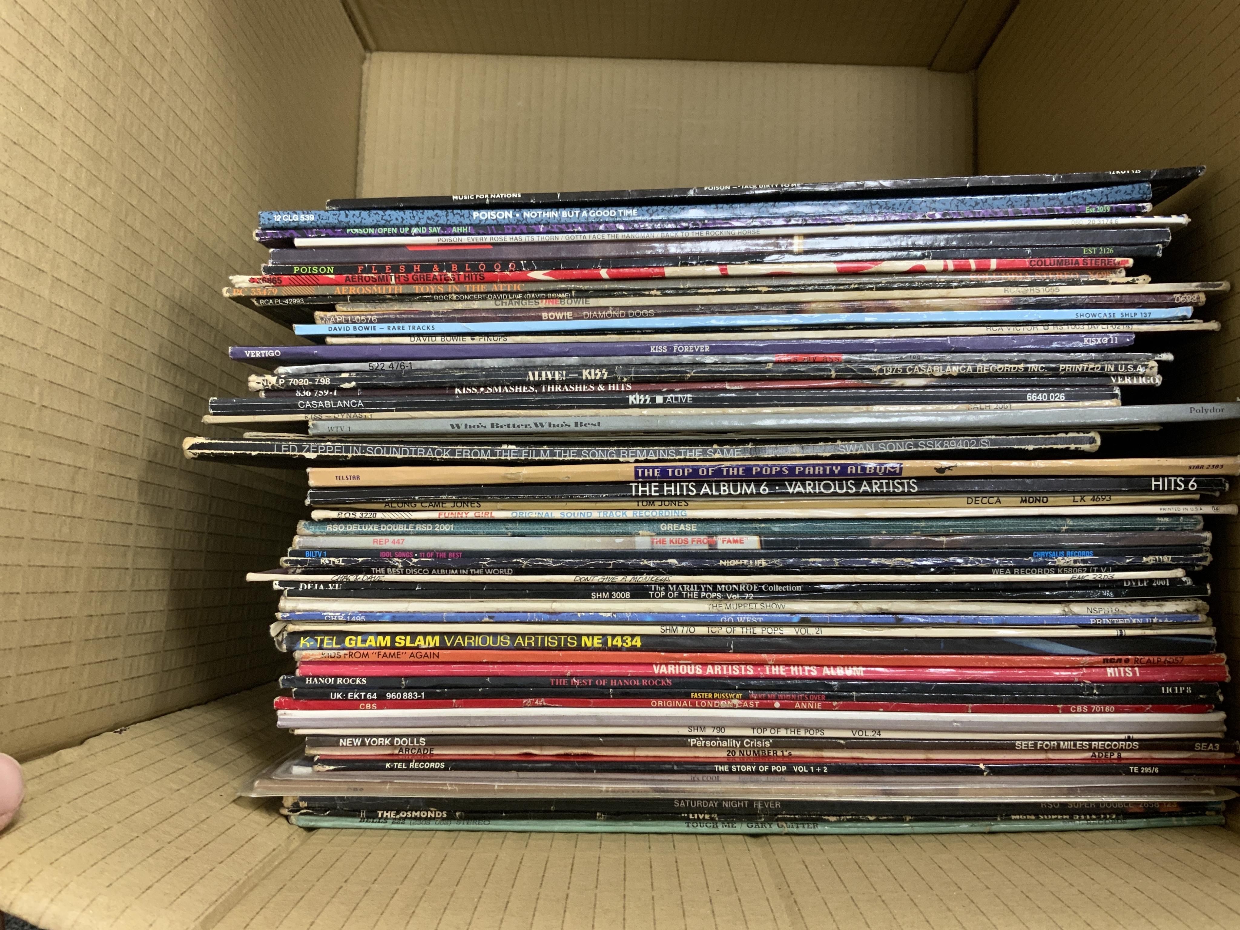 Fifty-six LP record albums, 12” singles, compilations and soundtracks, artists including; Poison, David Bowie, Kiss, Led Zeppelin, INXS, etc. Condition - fair to good